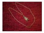 Gold Clown pendant and chain. Used: An item that has....